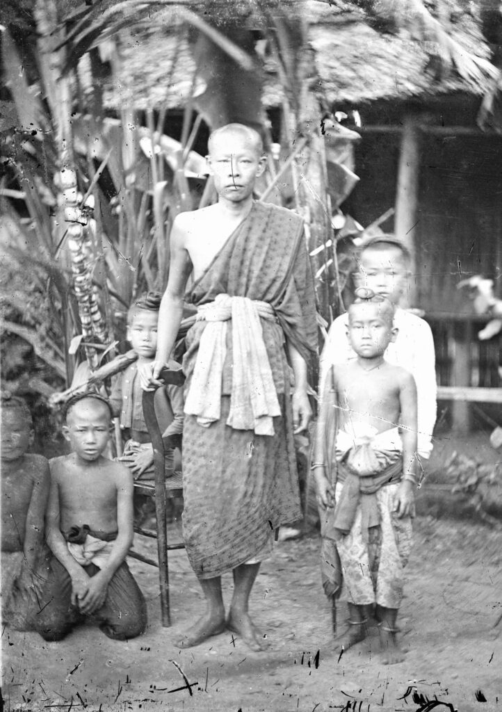 พระสงฆ์ไทย สมัย ร.4 ห่ม จีวรลายดอกพิกุล ยืน กับ เด็ก
